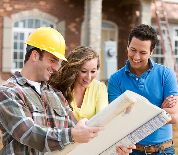 Property agent discussing custom property development plans with a couple.