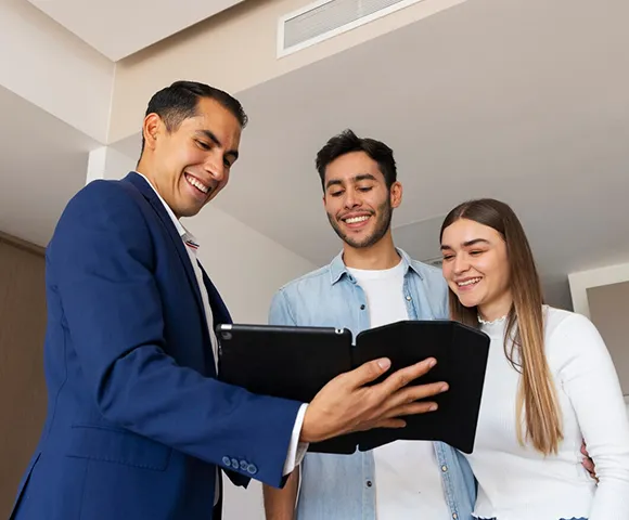 Property agent showing real estate options to a couple on a tablet.