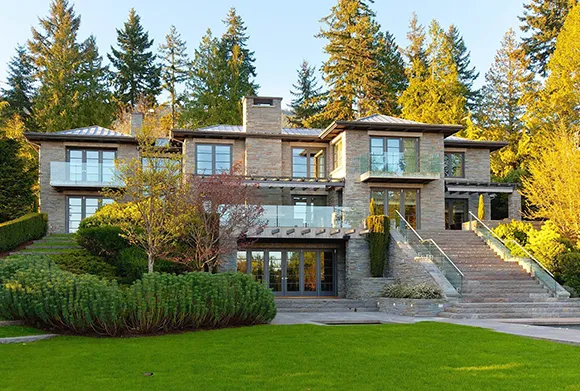 Beautifully designed home featuring a stunning landscape and vibrant trees, perfect for an upscale family lifestyle.